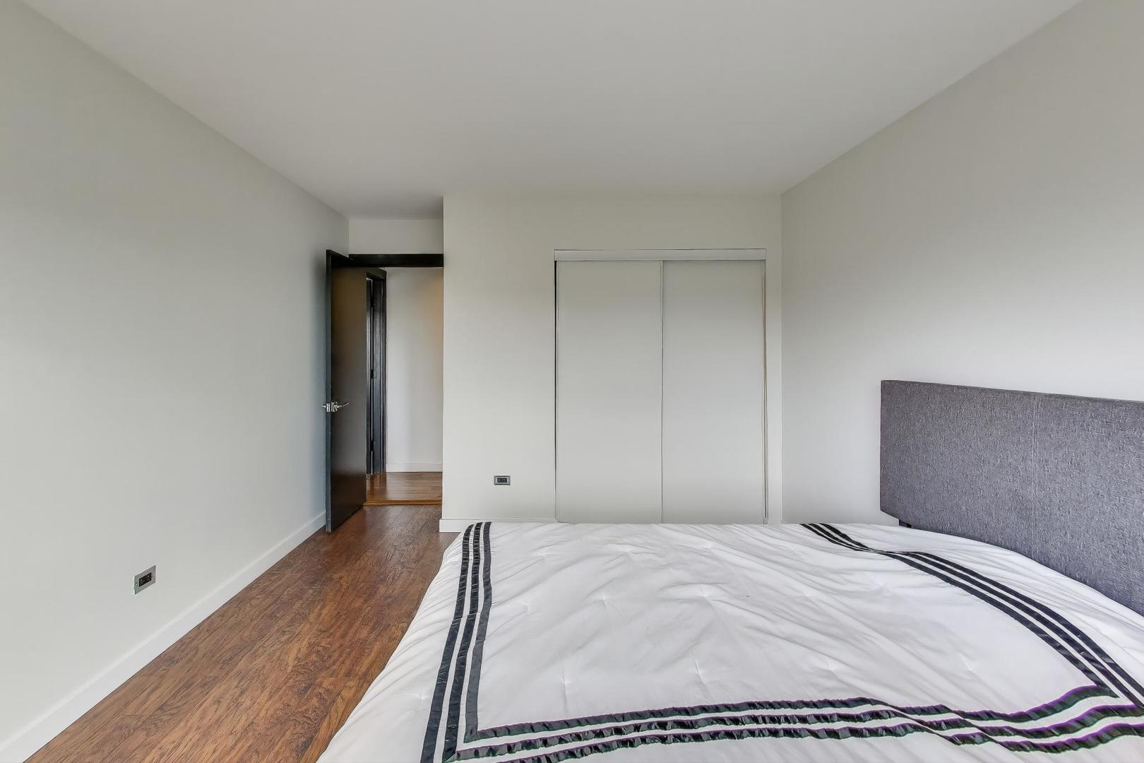 1717 West Crystal Lane, Unit 610 Mount Prospect, IL 60056 - Photo 15 of 23 a bedroom with a bed and wooden floor