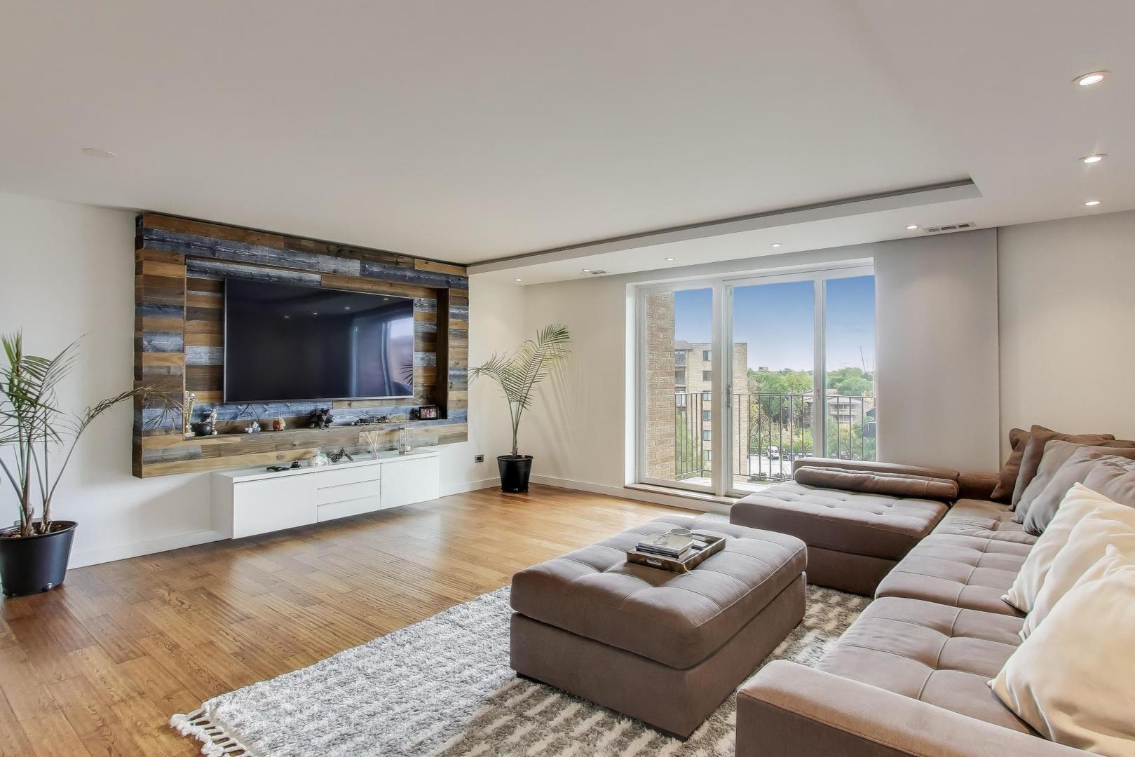 1717 West Crystal Lane, Unit 610 Mount Prospect, IL 60056 - Photo 5 of 23 a living room with furniture and a flat screen tv