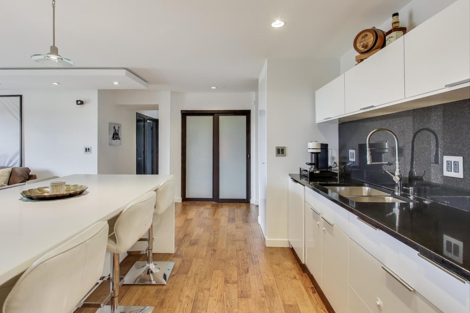 1717 West Crystal Lane, Unit 610 Mount Prospect, IL 60056 - Photo 9 of 23 a kitchen with granite countertop a sink and cabinets