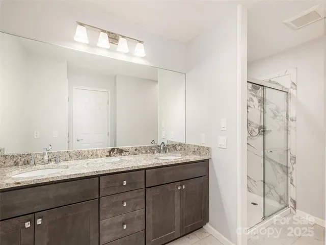a bathroom with a granite countertop sink mirror and double