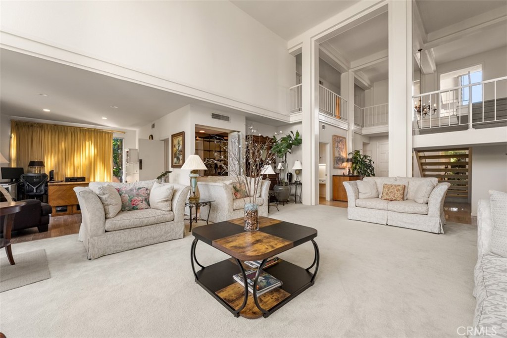 10 Rue Valbonne Newport Beach, CA 92660 - Photo 27 of 66 a living room with furniture a rug kitchen view and a large window
