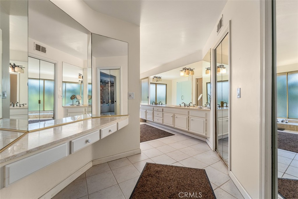 10 Rue Valbonne Newport Beach, CA 92660 - Photo 31 of 66 a bathroom with a glass shower door and a bathtub