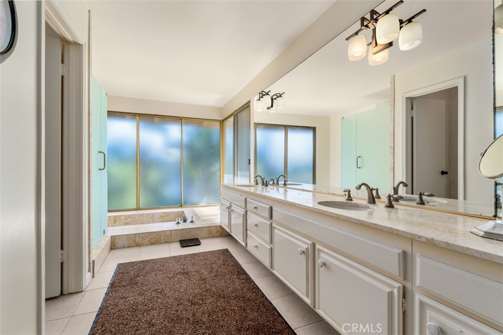10 Rue Valbonne Newport Beach, CA 92660 - Photo 32 of 66 a spacious bathroom with a tub sink and mirror
