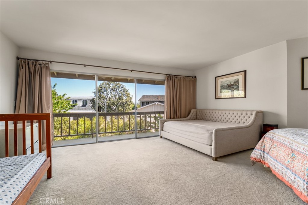 10 Rue Valbonne Newport Beach, CA 92660 - Photo 36 of 66 a spacious bedroom with a bed and a large window