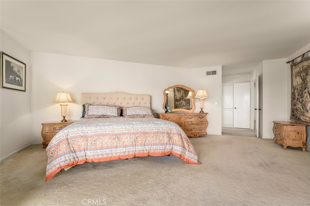 10 Rue Valbonne Newport Beach, CA 92660 - Photo 37 of 66 a bedroom with a bed and a view of en suite bathroom