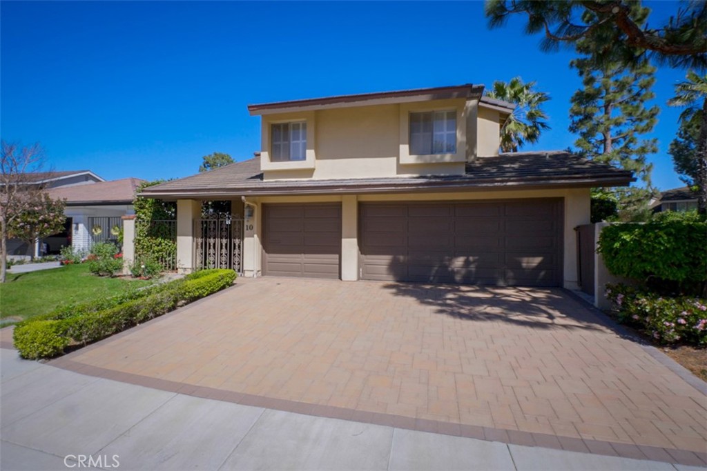 10 Rue Valbonne Newport Beach, CA 92660 - Photo 4 of 66 a front view of a house with a yard and garage