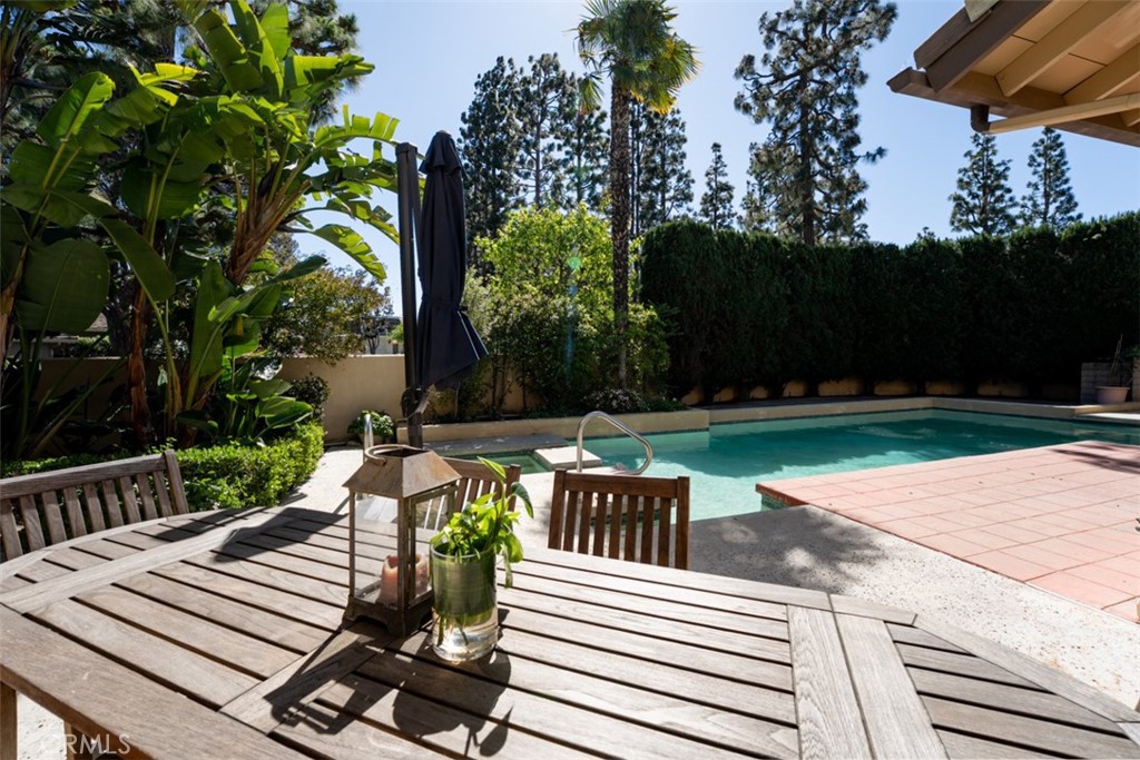 10 Rue Valbonne Newport Beach, CA 92660 - Photo 45 of 66 a view of a patio with table and chairs potted plants and large tree