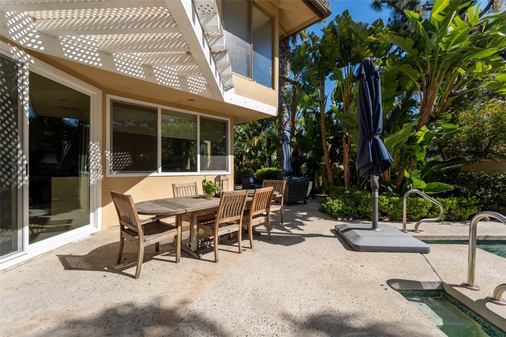 10 Rue Valbonne Newport Beach, CA 92660 - Photo 49 of 66 a view of a patio with table and chairs and potted plants