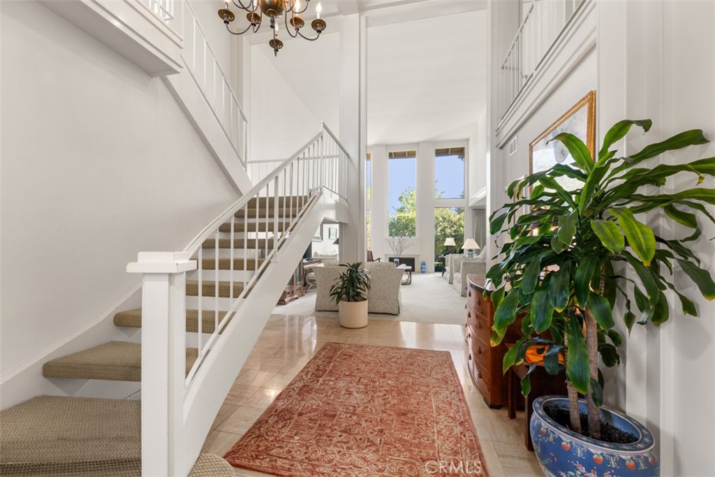 10 Rue Valbonne Newport Beach, CA 92660 - Photo 7 of 66 a view of staircase with wooden floor and a potted plant