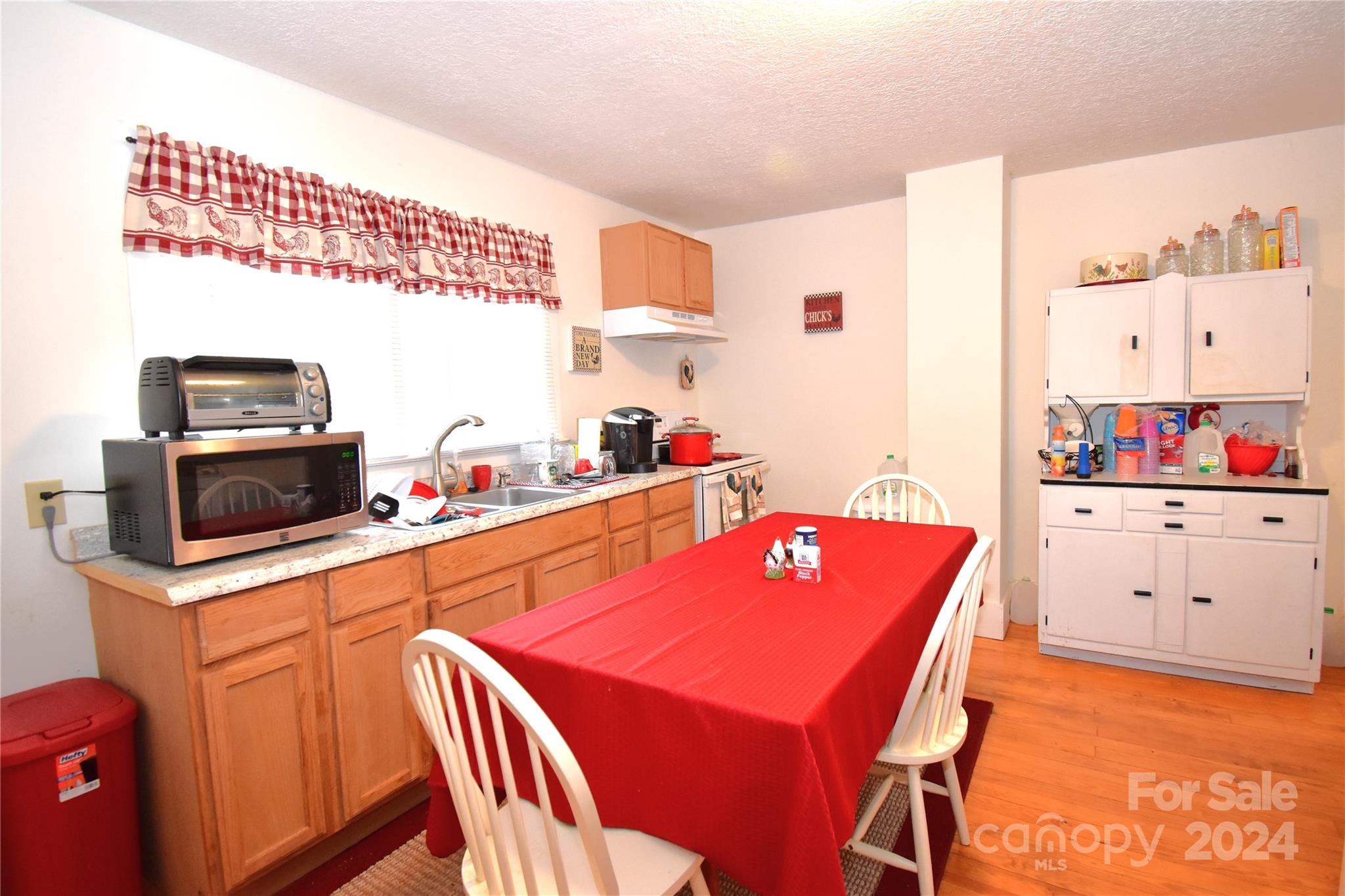 116 Warner Road Canton, NC 28716 - Photo 7 of 22 a kitchen with stainless steel appliances kitchen island granite countertop a dining table chairs stove and a refrigerator