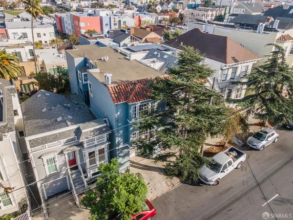 an aerial view of residential houses with outdoor space