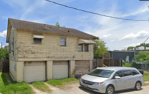 a front view of a house with parking space