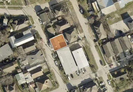 an aerial view of a house with a yard