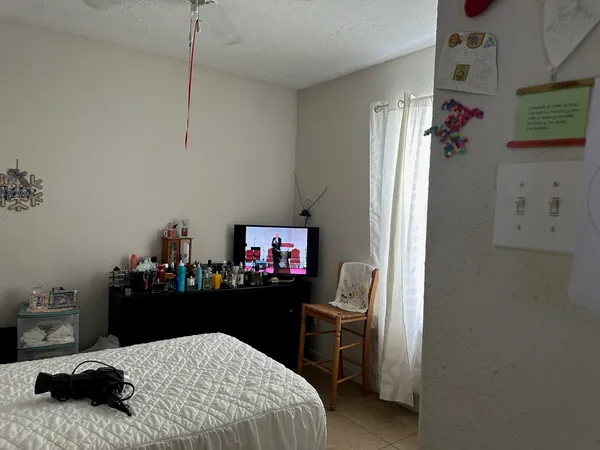 a bedroom with a bed and a chandelier