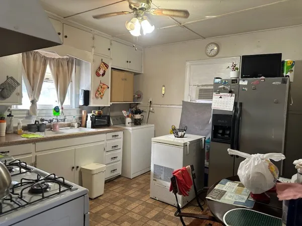 a kitchen with a sink appliances and cabinets
