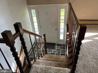 a bathroom with a granite countertop toilet and a sink