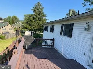 a view of a house with wooden deck
