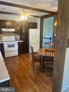 a kitchen with a wooden table and chairs