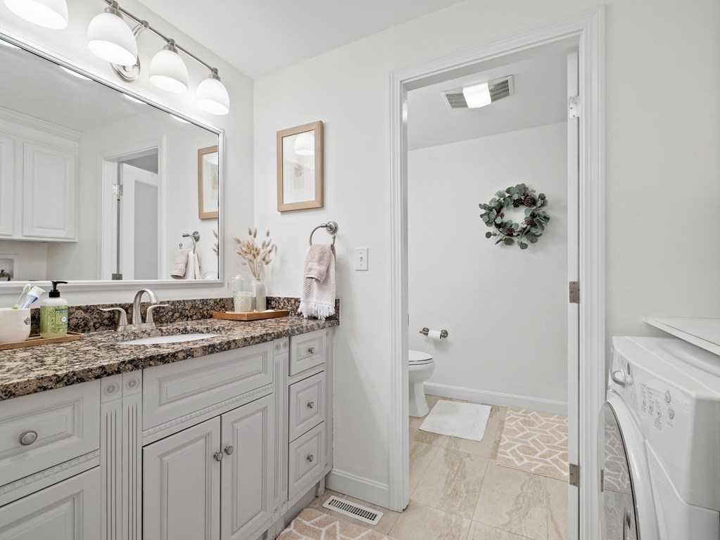 14 Jericho Road, Unit 14 Weston, MA 02493 - Photo 15 of 17 a bathroom with a granite countertop sink and a mirror