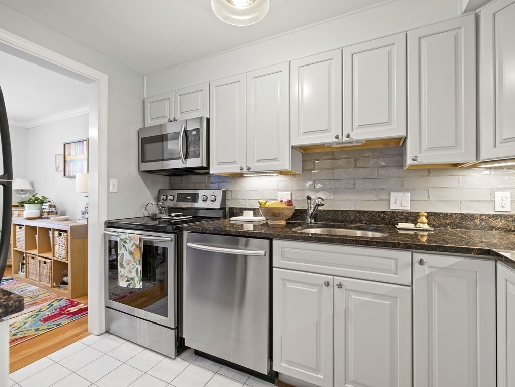 14 Jericho Road, Unit 14 Weston, MA 02493 - Photo 3 of 17 a kitchen with stainless steel appliances granite countertop a stove a sink and a white cabinets