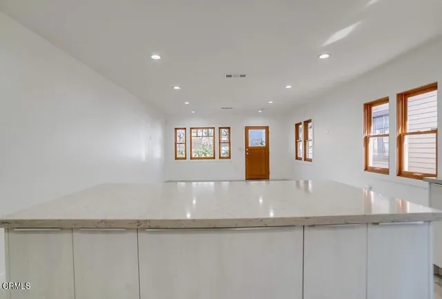 a view of kitchen with center island and windows
