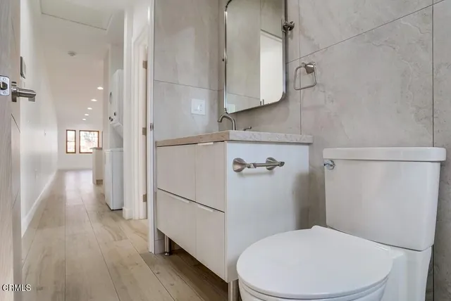 a white toilet sitting next to a bathroom sink