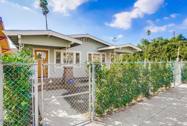 a front view of a house with yard and green space