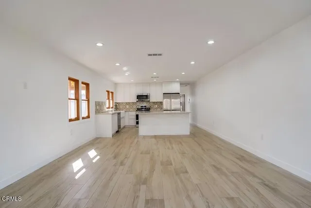 a view of kitchen dining table chairs and cabinets