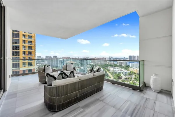 a living room with furniture and a floor to ceiling window