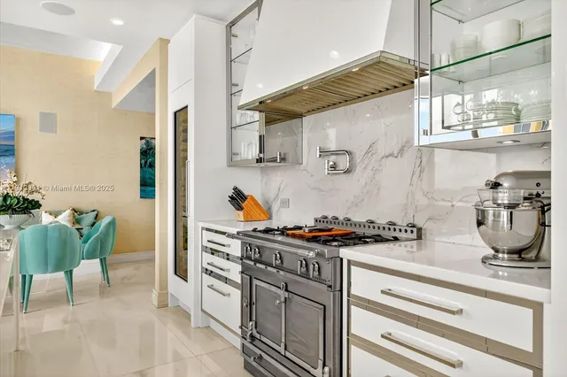 a kitchen with stainless steel appliances a sink a stove and a refrigerator