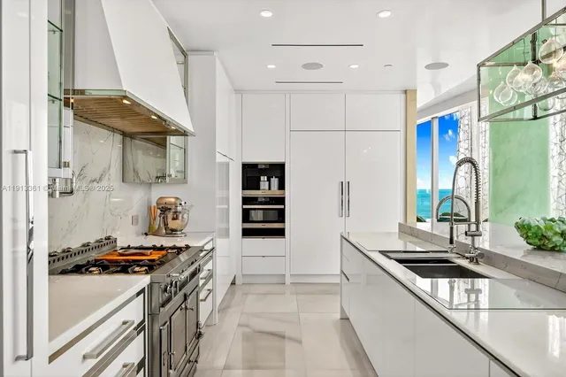a kitchen with counter top space and living room