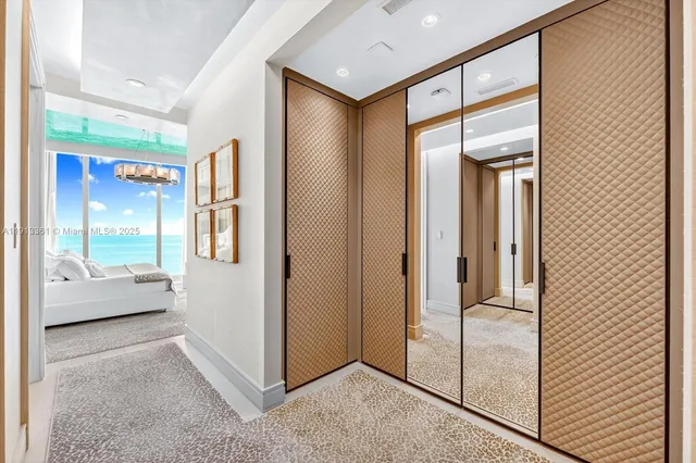 a bathroom with a sink and mirror with bathtub