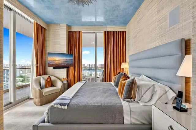 a bedroom with a bed and a chandelier