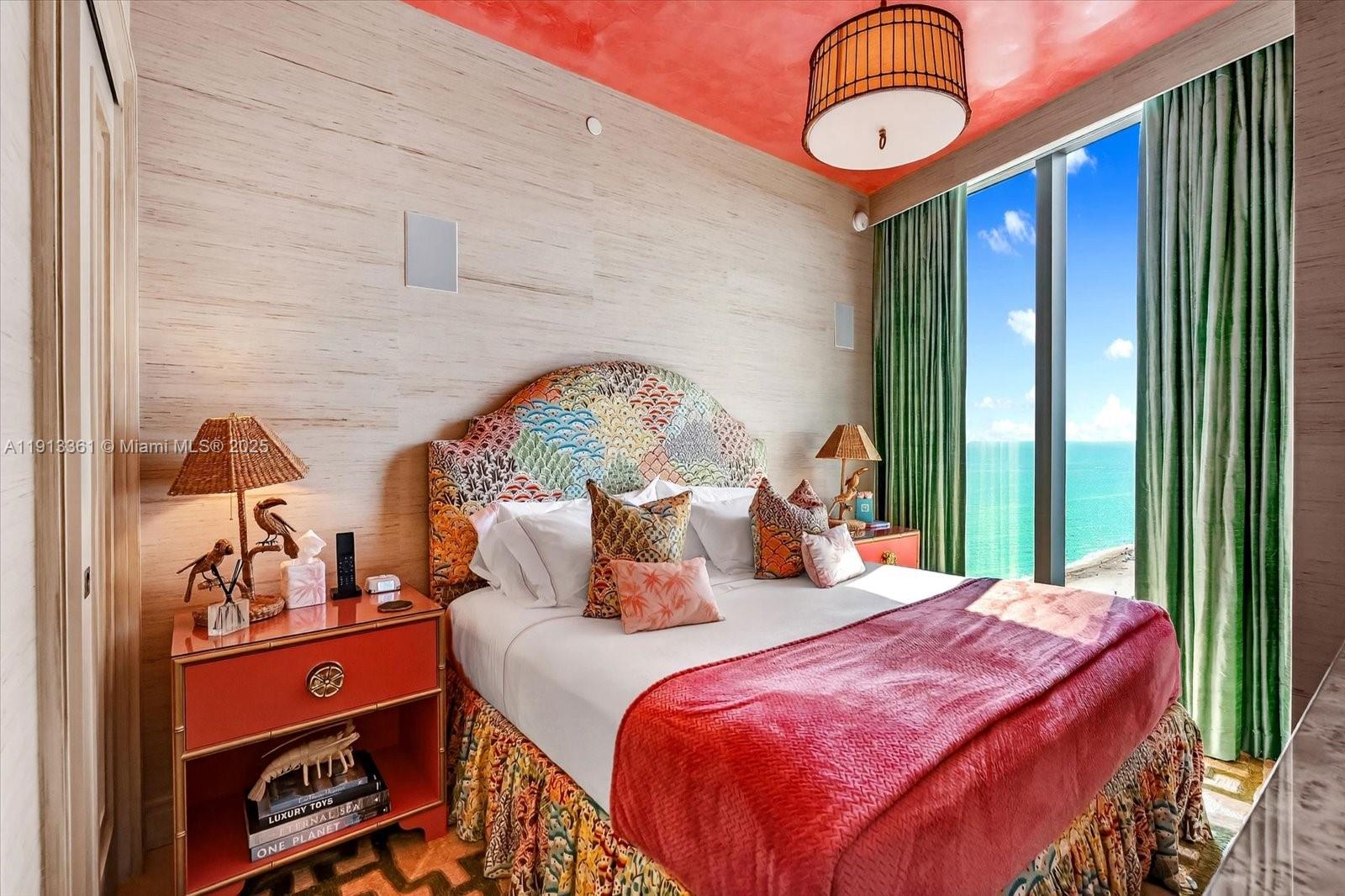 17901 Collins Avenue, Unit 2004 Sunny Isles Beach, FL 33160 - Photo 45 of 55 a bedroom with a bed and a chandelier