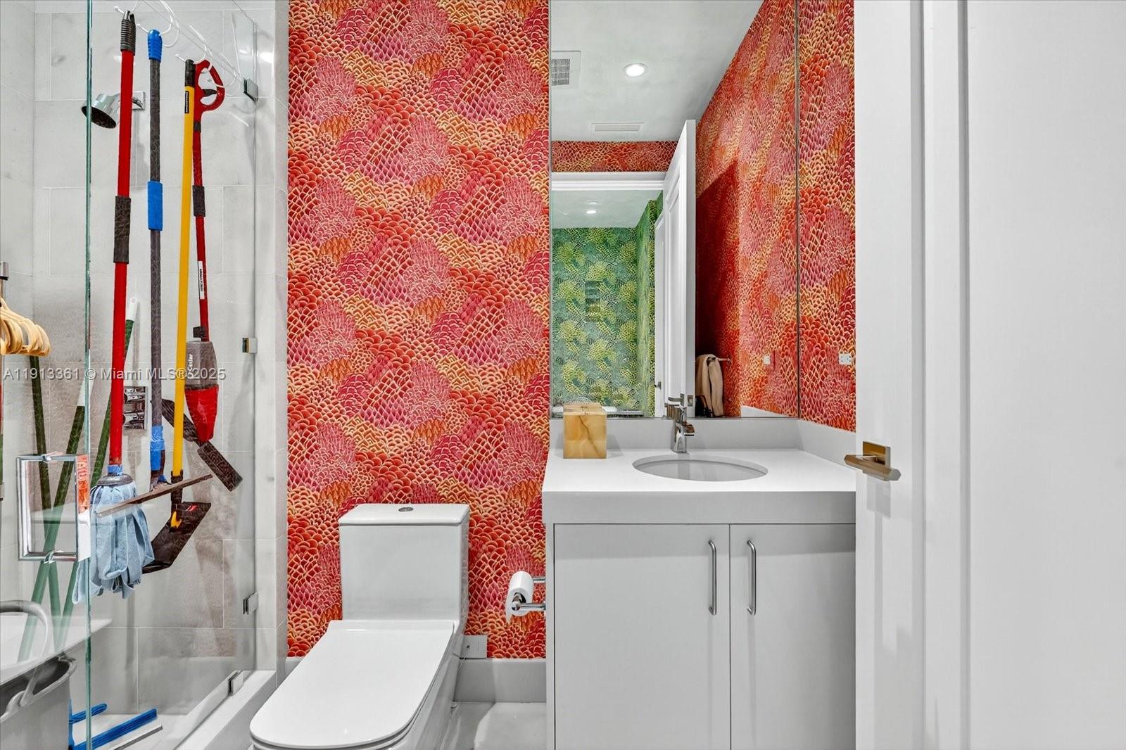 17901 Collins Avenue, Unit 2004 Sunny Isles Beach, FL 33160 - Photo 51 of 55 a bathroom with a sink vanity mirror and toilet