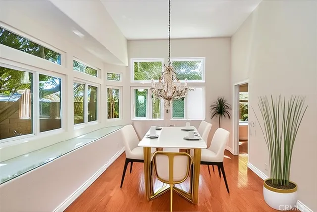 a view of a big room with wooden floor and a bathroom