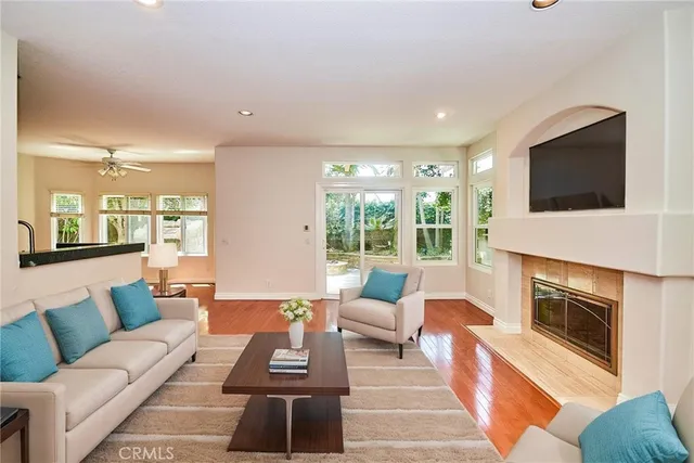 a view of empty room with wooden floor and fireplace