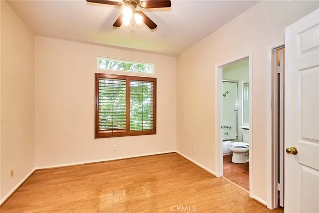 a spacious bedroom with a large bed and a chandelier