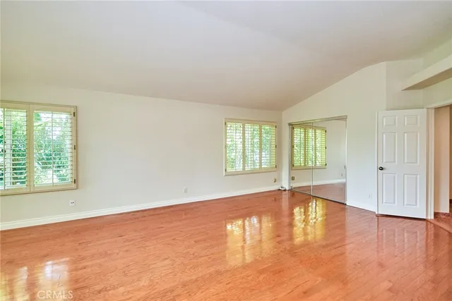 a view of an empty room with window and fire place