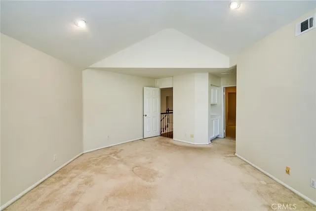 an empty room with windows and closet