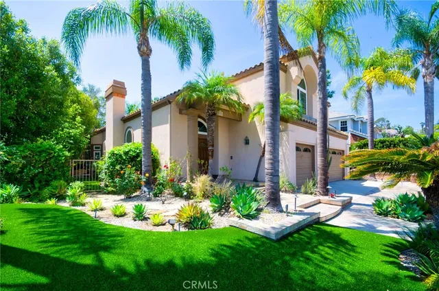 a front view of a house with swimming pool and garden