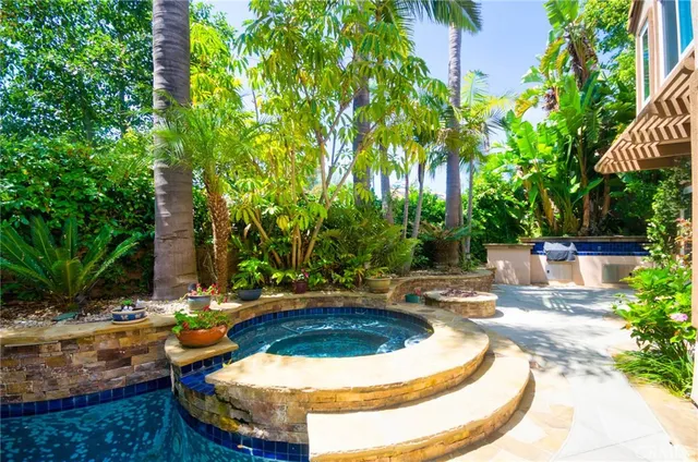 a front view of a house with a yard and fountain