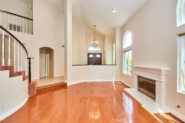 a living room with furniture fireplace and a large window