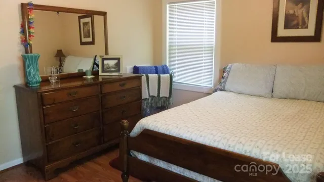 a bedroom with a bed and a mirror