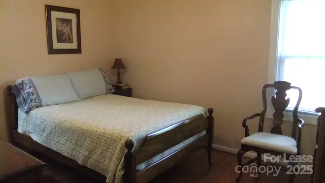 a bed room with a bed and a chair