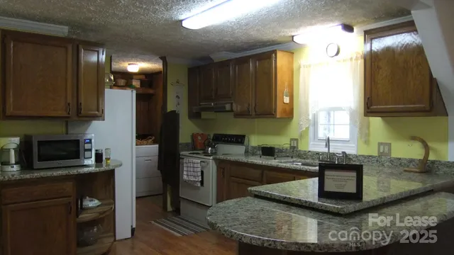 a kitchen with a sink stove and refrigerator
