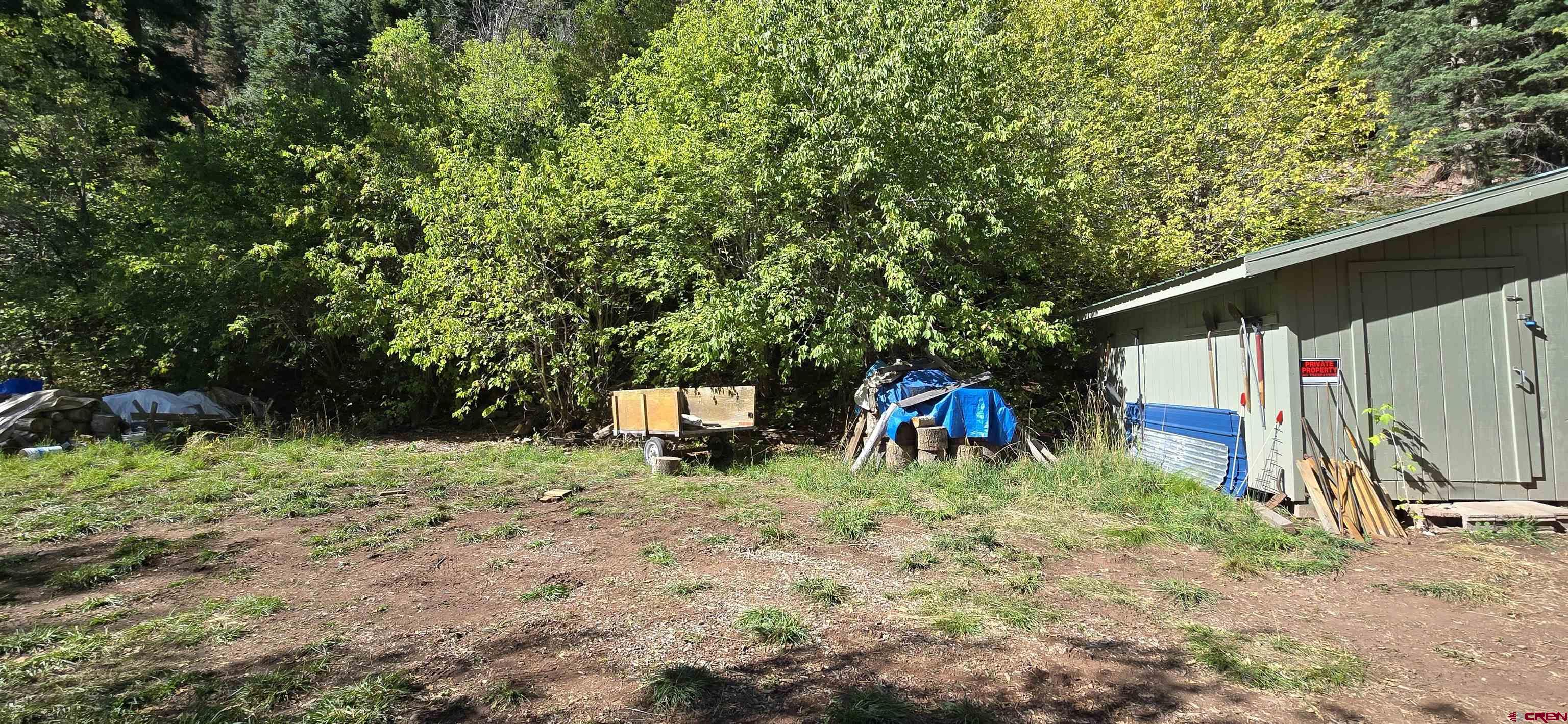 Tbd Oak Street Ouray, CO 81427 - Photo 7 of 14 a backyard of a house with table and chairs