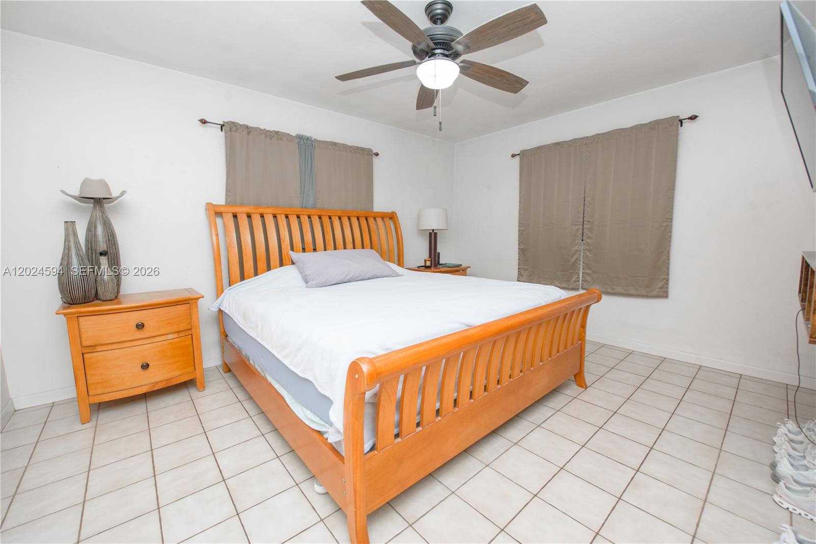 17355 Southwest 256th Street Homestead, FL 33031 - Photo 12 of 32 a bedroom with a bed and a dresser