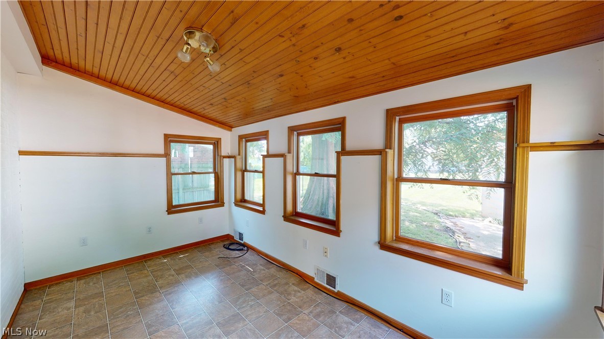 4334 West Anderson Road South Euclid, OH 44121 - Photo 7 of 12 Sun Room featuring a wealth of natural light, wooden ceiling, tile floors, and vaulted ceiling