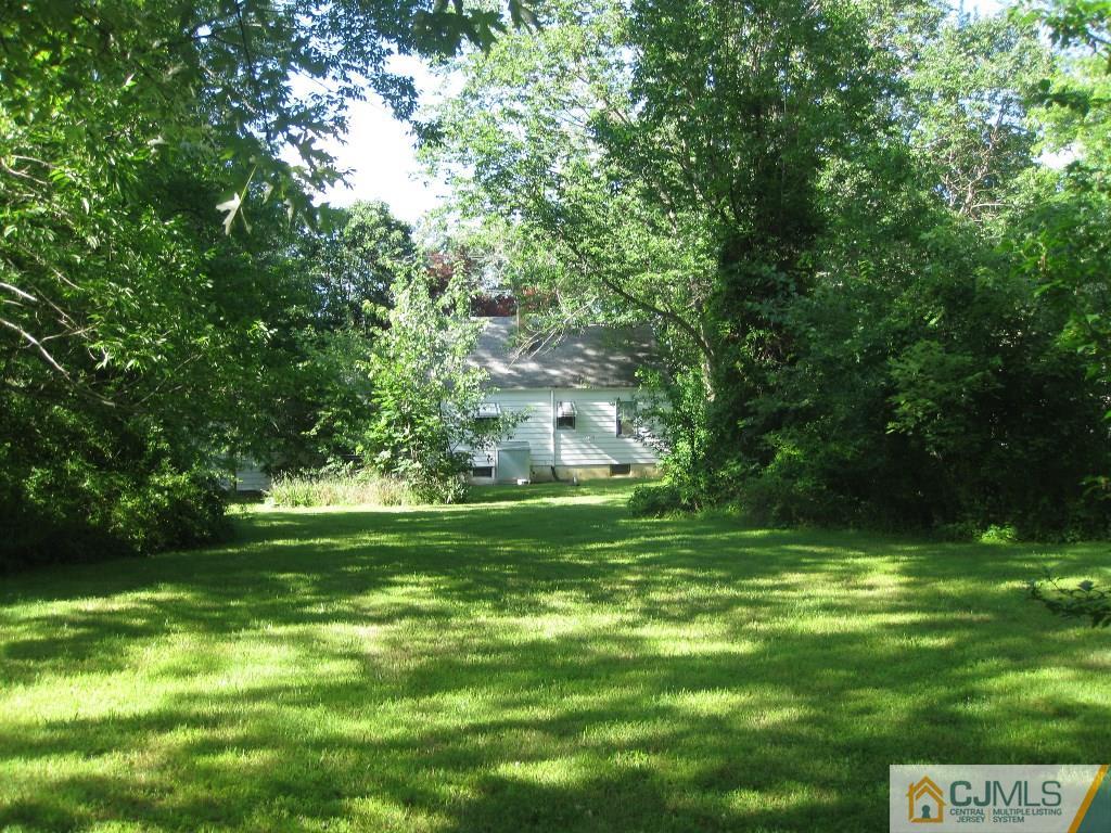 188 Texas Road Old Bridge, NJ 08857 - Photo 2 of 7 a backyard of a house with lots of green space and garden